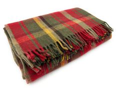 a red and green plaid blanket on a white background