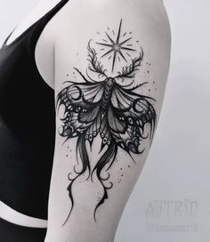 a woman's shoulder with an intricate tattoo design on the back of her arm