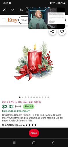 a cell phone with an image of a red candle and holly wreath on the screen