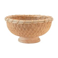 a wooden bowl that is sitting on a white surface with an intricate design in the center