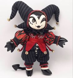 a stuffed animal dressed in black and red