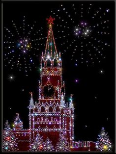 a large clock tower covered in christmas lights