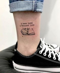 a woman's foot with a book tattoo on her left ankle and the words i have lived in thousand lives