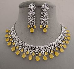 Designer CZ Diamonds Yellow Necklace Earrings Set, Bridal Dangler Earrings, Engagement Necklace, Haldi Necklace Earrings, Statement Piece,  ITEM DESCRIPTION Metal        = Antique/Silver Plated Occasion  = Wedding, Party Wear, Bridal Colour        = White and Yellow Size          = Necklace Length = 7 Inches Long, Earring Size = 2.5 Inches Long,  Free Shipping 100% Satisfaction Guarantee: 1 Year Warranty, Long Lasting Plating, High-Quality Stones Occasion: Perfect choice for any Indian occasion. Yellow Jewelry Necklace, Engagement Necklace, Engagement Necklaces, Long Earring, Bridal Choker, Wedding Party Wear, Dangler Earrings, Bridal Necklace Set, Yellow Necklace