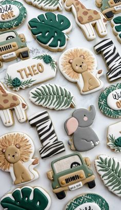 many decorated cookies with animals and plants on them