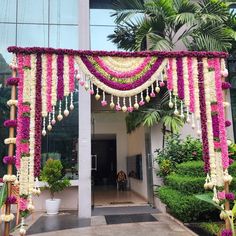 an entrance decorated with flowers and garlands