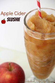 an apple cider slushie in a glass next to an apple