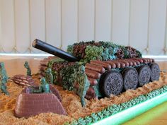 a cake that looks like a tank with soldiers on it