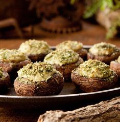 baked mushrooms with pesto and cheese on a plate