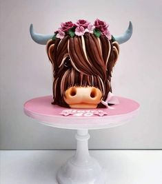 a cake decorated with a cow's head and flowers