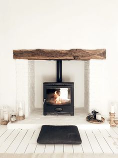 a wood burning stove in a white room