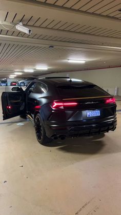 a black car is parked in a parking garage