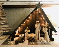 a nativity scene with figurines and lights