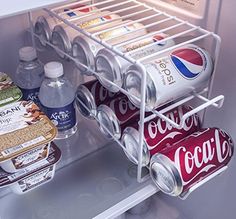 an open refrigerator filled with soda and other drinks