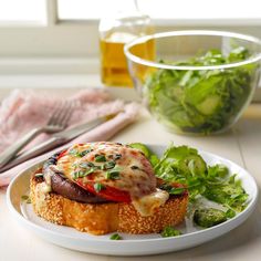 a white plate topped with food next to a salad