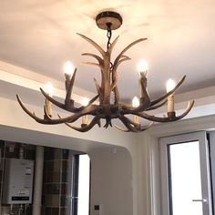 a deer antler chandelier hanging from the ceiling