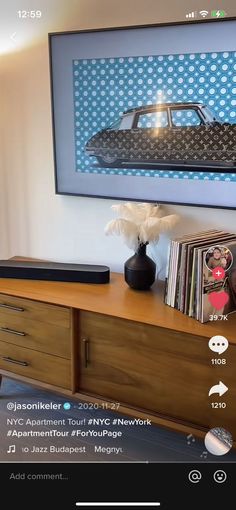 an image of a car on the wall above a table with records and record players