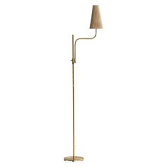 a floor lamp with a beige shade on it