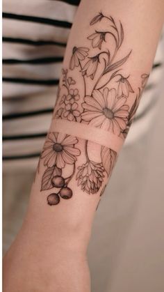 a woman's arm with flowers on it