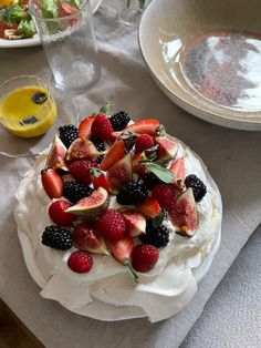 a cake with fruit on it sitting on top of a table