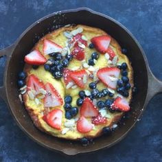 a pancake with berries and almonds in it