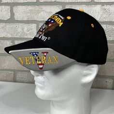 a black hat with an american flag and the words veteran on it sits on a mannequin head