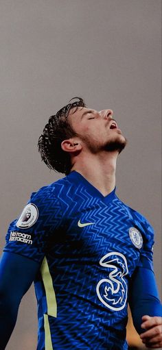 a soccer player is looking up to the sky with his eyes closed and head tilted