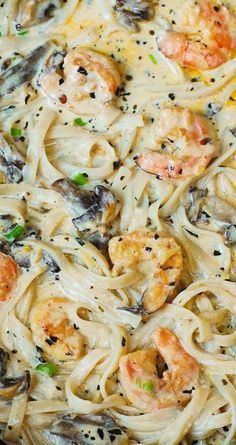 pasta with shrimp and mushrooms in a skillet on a wooden table, ready to be eaten