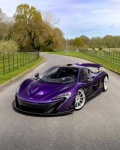 a purple sports car parked on the side of a road