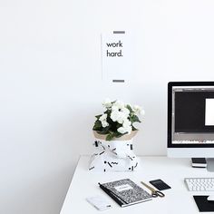 a white desk topped with a computer monitor and keyboard