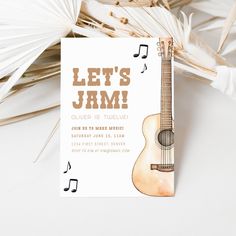 an acoustic themed birthday party with a guitar and music notes on the front, let's jam