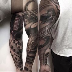 two men with tattoos on their arms and legs