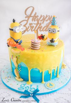 a birthday cake with two minion characters on it