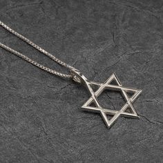 "Star Of David Necklace - The Star of David Necklace is a timeless and iconic piece of jewelry that holds deep cultural and religious significance. Also known as the Magen David or Shield of David, it is a symbol associated with Judaism and is widely recognized around the world. MATERIALS * Material: High-Quality 925 Sterling Silver  * Gold Plating options: 24K Gold Plating * Handmade item SIZES * Pendant size: Height: 16mm Width: 20mm * Pendant Thickness: 0.7mm * Chain Length: 14\" / 16\" / 18\ Engraved Sterling Silver Star Of David Necklace, Classic Star-shaped Necklace As Gift, Classic Star-shaped Necklace For Gift, Classic Star Shaped Necklace For Gift, Classic Star Of David Jewelry For Anniversary, Classic Star Of David Jewelry For Gift, Symbolic Star Of David Engraved Necklace, Classic Star Of David Necklace As Gift, Classic Star Of David Necklace For Gift