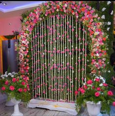 an arrangement of flowers and greenery on display at a wedding ceremony or reception venue