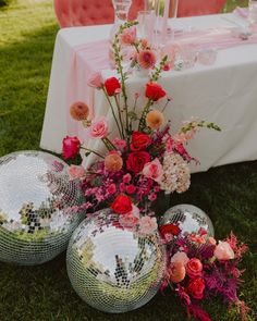 disco ball centerpieces and flowers on the grass