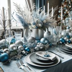 a table set for christmas with silver and blue decorations