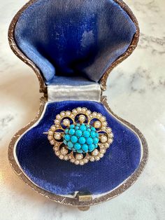 An elegant antique Victorian brooch in 15K yellow gold. The domed body is set with pave cabochon turquoise in shades of lovely robin's egg blue. The scalloped border is set with creamy white seed pearls. Stamped 15ct on reverse. 1 inch long, 3/4 inch wide, and weighs 6.2g. As gorgeous with jeans and a white t-shirt as it is with formal dress.  In excellent antique condition. Pearls and turquoise are all securely set, and the buttery gold back is smooth with only light surface wear. The pin is sl Victorian Brooch, Scalloped Border, Robin's Egg Blue, Pearl Brooch, Robins Egg Blue, Seed Pearl, Cute Pins, Creamy White, Antique Victorian