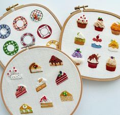 three embroidery hoop frames with different designs on them