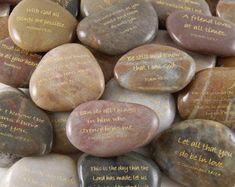 some rocks with writing on them sitting next to each other in the shape of hearts