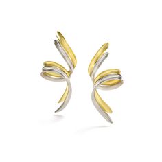 two tone gold and silver earrings with swirls on the outside, set against a white background