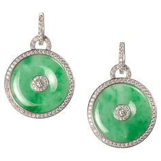 A pair of modern jade and diamond drop earrings, comprised of circular discs of polished green jade, with a round cluster of brilliant-cut diamonds in the centre, further surrounded by a border of diamonds, and diamond-set hoop fittings, all mounted in 18ct white gold. The estimated total diamond weight is 4.50 carats. Donuts Earrings, Jewellery Sketches, Pearl Hoop Earrings, Jade Stone, Antique Earrings, Diamond Drops, Diamond Drop Earrings, Diamond Set, Onyx Stone