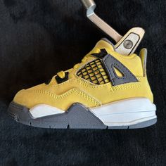 SneakerHead Covers are upcycled or new kid's sneakers that fit your putter! We're sourcing the best from Jordan, Yeezy, Nike and others to bring your sneaker game to the course.  These covers are for blade or mid-mallet style putters only. Sale is for 1 sneaker putter cover.  Jordan 4 Lightning Yellow (Upcycled: will show signs of use. see pics for condition close-ups) Putter Cover, Jordan Yeezy, Golf Putter, Golf Putters, Custom Golf, Des Baskets, Sneaker Games, Outdoor Games, Kids Sneakers