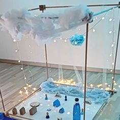 an artistic display with blue bottles and lights