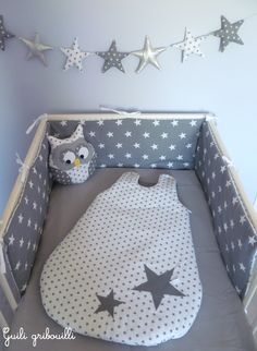 a baby crib with an owl and stars on it