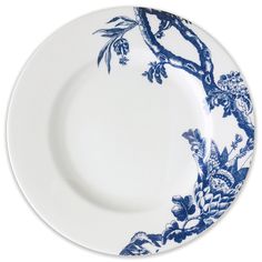 a blue and white plate with an image of birds on the branch in the center