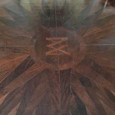 a wooden floor with an artistic design on it