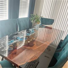 a wooden table with blue chairs around it