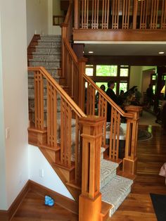 the stairs are made of wood and have handrails that lead up to the second floor