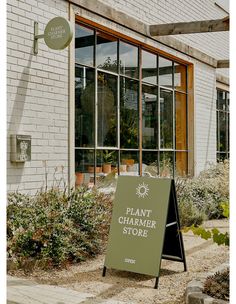 a sign in front of a building that says plant charmer store on the side